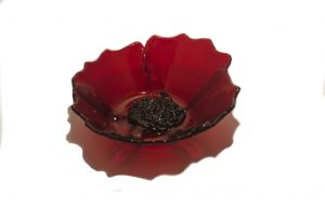 Glass bowl of red transparent glass with black textured center